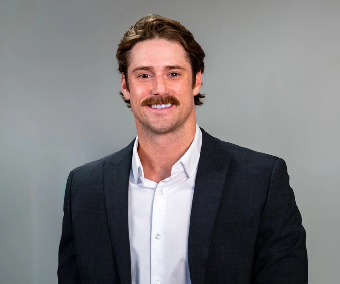 Shad Vedaa profession portrait of him standing in front of gray background