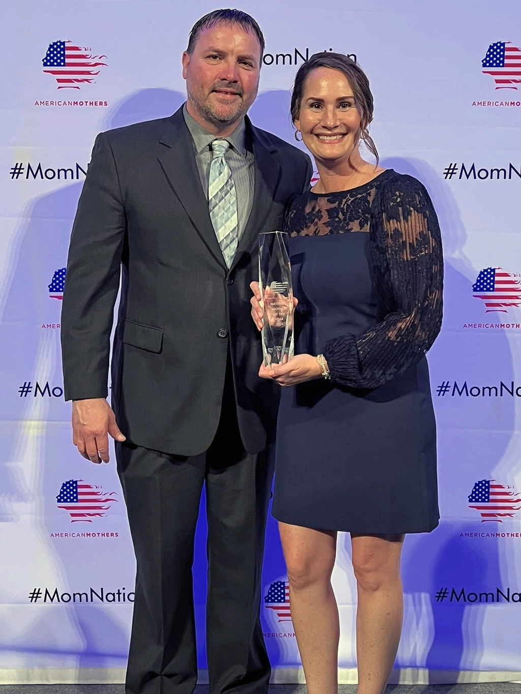 Jenessa with her husband and 2024 National Mother of the year award