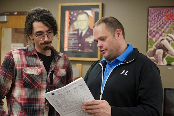 Transition service employee helping a student